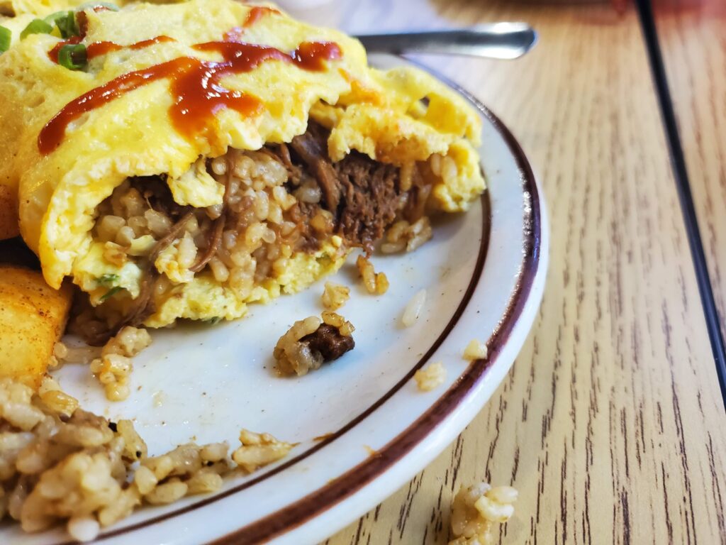 A forkful of the Lolo Rick's Adobo Fried Rice which is essentially a burrito