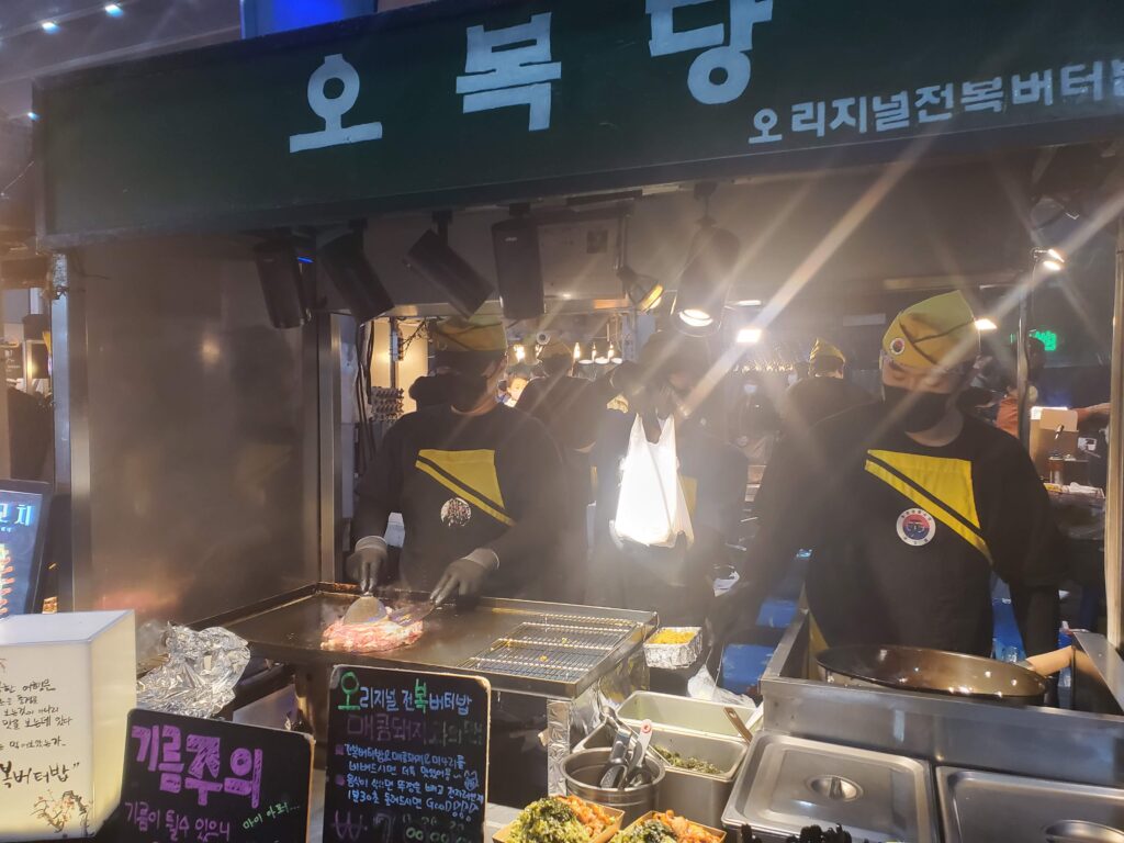 Cooks making the abalone butter rice and spicy pork