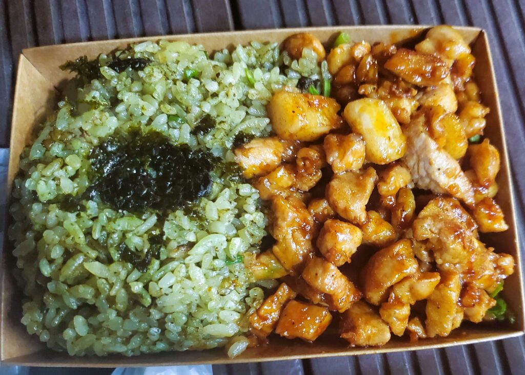 The abalone butter rice and spicy pork in its containter