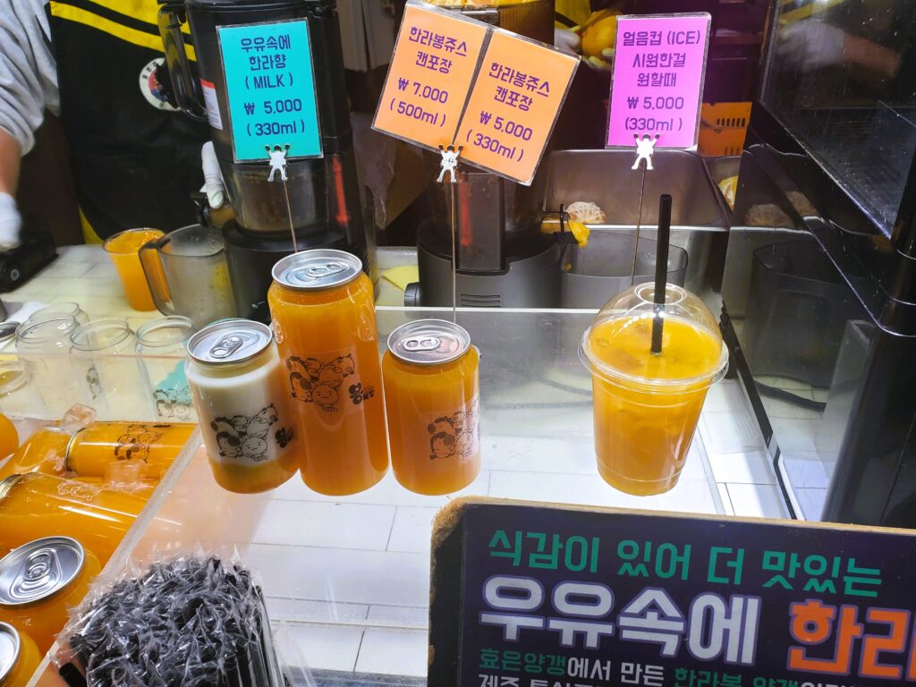 Different tangerine juice options showcased in front of the tangerine stall