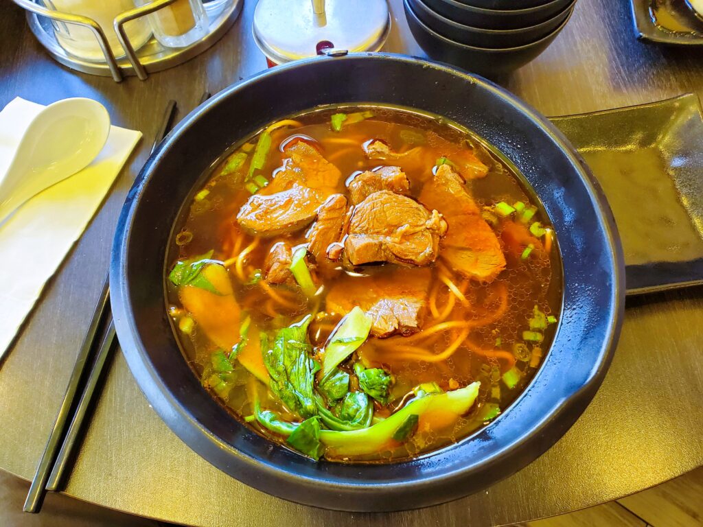 The beef noodle soup at A&J Restaurant in Irvine with thin noodles, beef, and greens