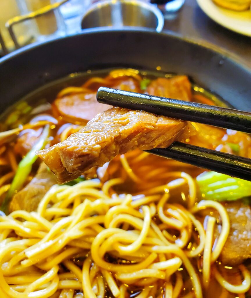 The beef noodle soup at A&J Restaurant in Irvine showing a tender piece of beef