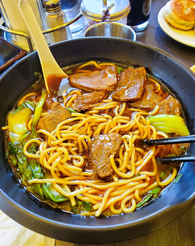 The beef noodle soup at A&J Restaurant in Irvine with thin noodles, beef, and greens